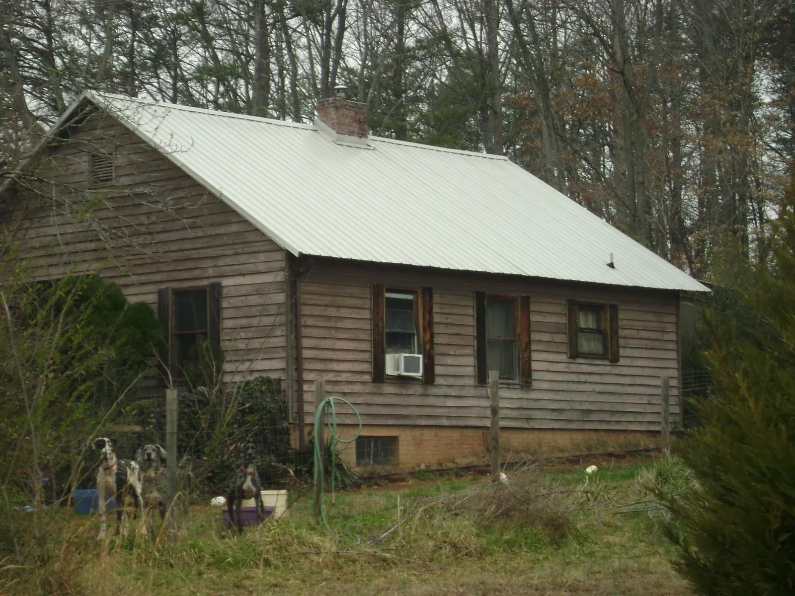 White metal roof on an old wood sided farmhouse, from a Metal Roof Installation job in Condon