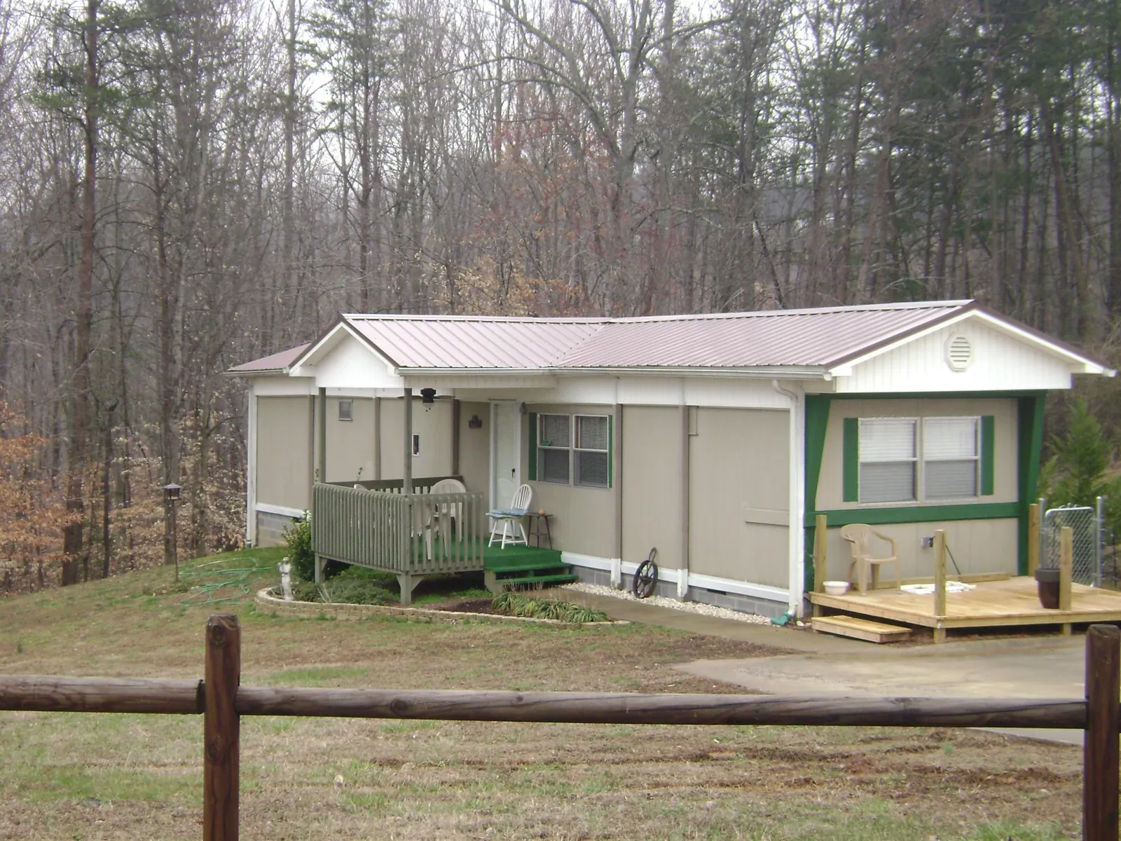 Mauve metal roof on a manufactured home with a new front deck in Condon
